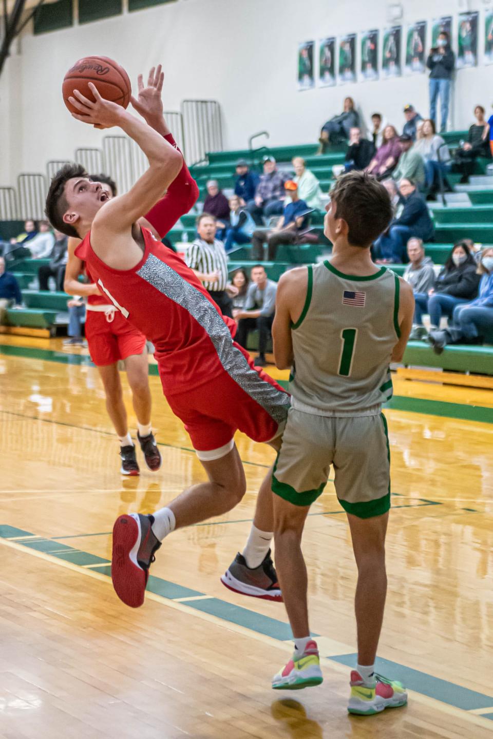 Coldwater's Ethan Crabtree takes an off-balanced shot over Pennfield's Luke Davis during first half action at Pennfield High School on January 18, 2022.