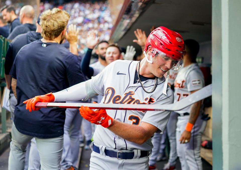 Detroit Tigers'  Kerry Carpenter holds a hockey stick and wears a helmet in the dugout during the fifth inning as he celebrates his second home run in a game against the Seattle Mariners at T-Mobile Park in Seattle on Saturday, July 15, 2023.