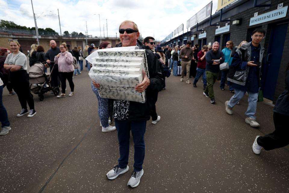 Taylor Swift fans line up outside Murrayfield Stadium before the concert begins in Edinburgh, Scotland on June 6. Taylor Swift's Eras World Tour includes 15 concerts in Scotland, Wales and England in June and August.