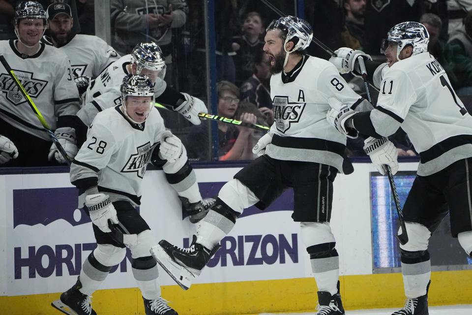 Los Angeles Kings' Drew Doughty (8) celebrates his game winning goal with teammates Jaret Anderson-Dolan (28) and Anze Kopitar (11) in overtime of an NHL hockey game against the Columbus Blue Jackets, Tuesday, Dec. 5, 2023, in Columbus, Ohio. (AP Photo/Sue Ogrocki)