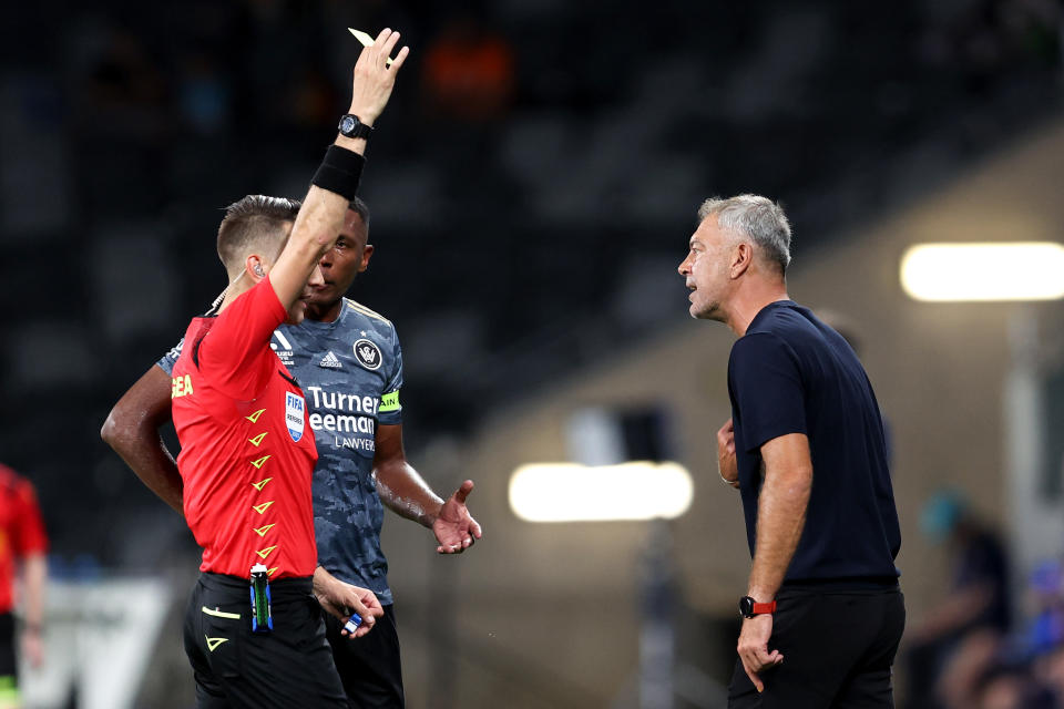 SYDNEY, AUSTRALIA - JANUARY 12: Referee, Jonathan Barreiro shows Wanderers coach, Mark Rudan a yellow card during the A-League Men round 12 match between Melbourne City and Western Sydney Wanderers at CommBank Stadium, on January 12, 2024, in Sydney, Australia. (Photo by Brendon Thorne/Getty Images)