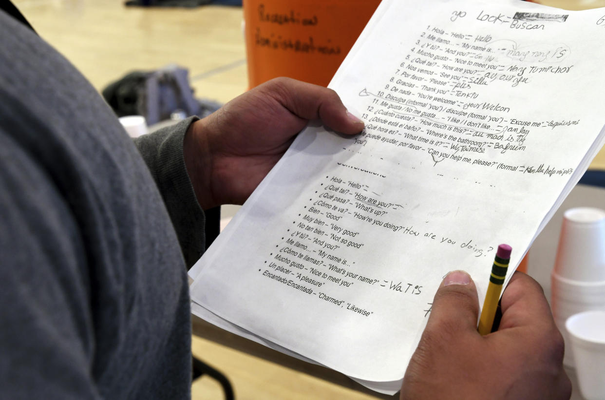 A migrant studies English at a makeshift shelter in Denver, Friday, Jan. 6, 2023. Over the past month, nearly 4,000 immigrants, almost all Venezuelans, have arrived unannounced in the frigid city, with nowhere to stay and sometimes wearing T-shirts and flip-flops. In response, Denver converted three recreation centers into emergency shelters for migrants and paid for families with children to stay at hotels, allocating $3 million to deal with the influx. (AP Photo/Thomas Peipert)