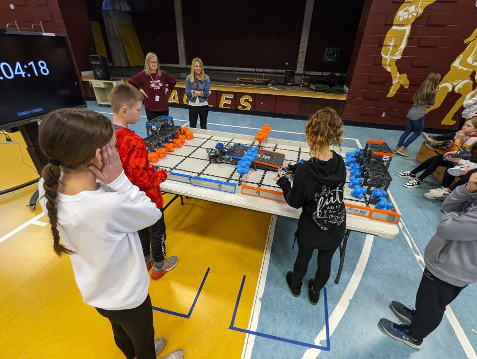 Students competing in Silver Lake Elementary School's VEX IQ robotics competition Friday morning had five minutes to score as many points as possible by maneuvering orange and blue balls around a wall and bridge on the competition table.