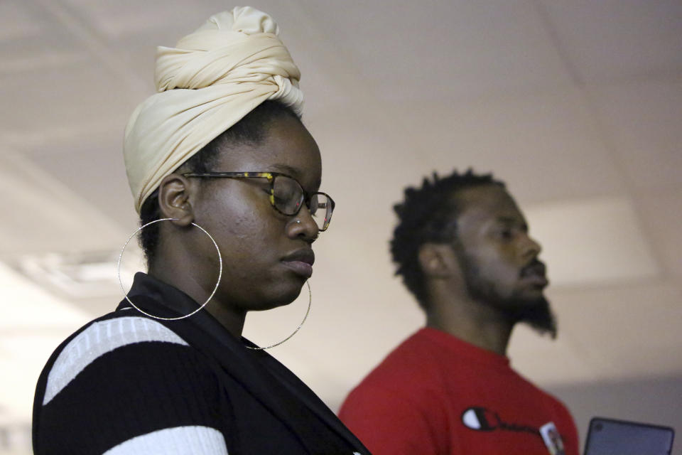 Victoria Williams and Menelik Tafari pray during an event by the Rastafari Coalition marking the 91st anniversary of the coronation of the late Ethiopian Emperor Haile Selassie I in Columbus, Ohio on Tuesday, Nov. 2, 2021. The coronation day event included chanting, traditional nyabinghi drumming and the reading of psalms, which are the core of Rastafari holiday celebrations. (AP Photo/Emily Leshner)