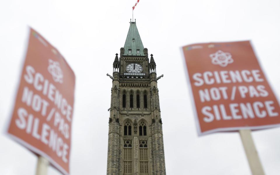 Demonstrators Attend The Ottawa March For Science Original description: The Peace Tower stands as demonstrators hold signs during the March for Science rally on Earth Day at Parliament Hill in Ottawa, Ontario - Credit: David Kawai/Bloomberg