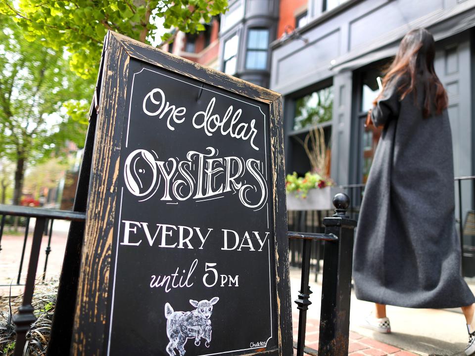 A sign advertises one-dollar oysters at Black Lamb in Boston on May 7, 2022.