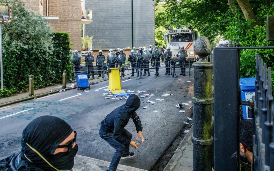 Pro-Palestinian demonstrators clash with riot police in front of Israel's embassy in Brussels on Wednesday