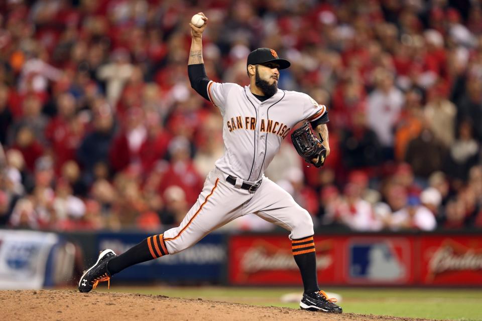 Sergio Romo #54 of the San Francisco Giants pitches in the 10th inning as the Giants defeat the Cincinnati Reds 2-1 in Game Three of the National League Division Series at the Great American Ball Park on October 9, 2012 in Cincinnati, Ohio. Romo earned the win in the victory. (Photo by Andy Lyons/Getty Images)
