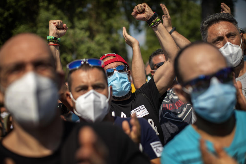 Nissan workers react during a protest outside their factory in Barcelona, Spain, Thursday, May 28, 2020. Japanese carmaker Nissan Motor Co. has decided to close its manufacturing plans in the northeastern Catalonia region, resulting in the loss of some 3,000 direct jobs. (AP Photo/Emilio Morenatti)