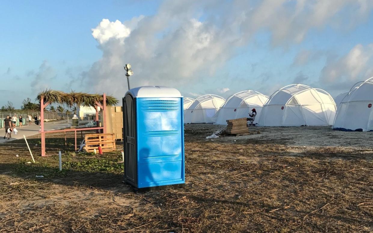 Tents and a portable toilet set up for attendees for the Fyre Festival, April 28, 2017 - Jake Strang via AP