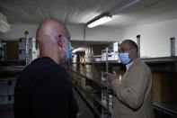 Caretaker Health Minister Hamad Hassan, right, inspects a medical warehouse in Beirut, Lebanon, Friday, June 11, 2021. Hassan raids warehouses in an effort to control those who are hoarding subsidized medical equipment and baby formula in order to sell them later at higher prices or on the black market. (AP Photo/Bilal Hussein)