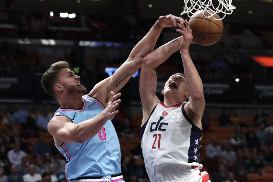 Washington Wizards forward Moritz Wagner (21) goes to the basket as Miami Heat forward Meyers Leonard defends during the first half of an NBA basketball game, Friday, Dec. 6, 2019, in Miami. (AP Photo/Lynne Sladky)