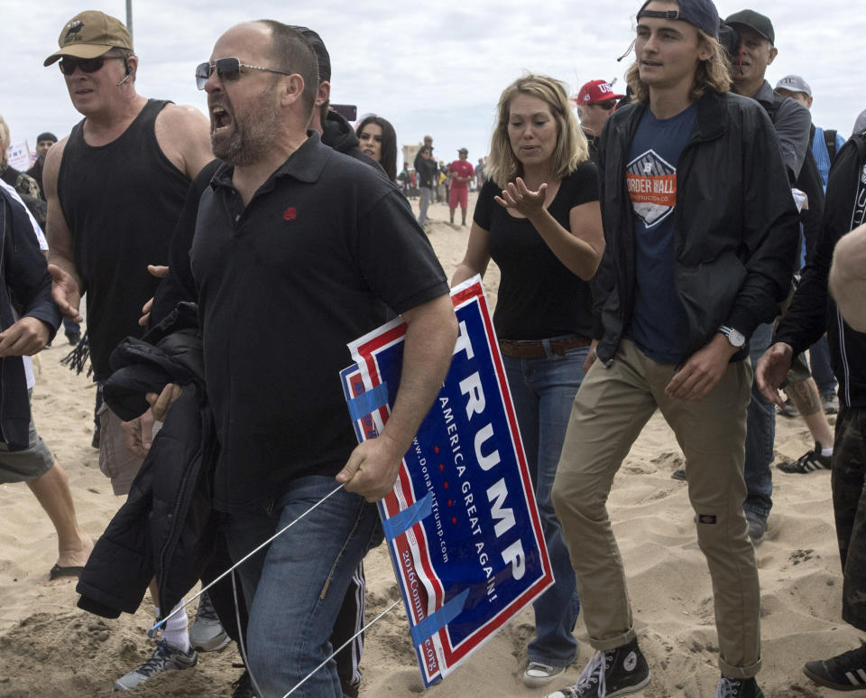 A President Donald Trump supporter yells at anti-Trump protesters during a clash in Huntington Beach, Calif., on Saturday, March 25, 2017. (Mindy Schauer/The Orange County Register via AP)