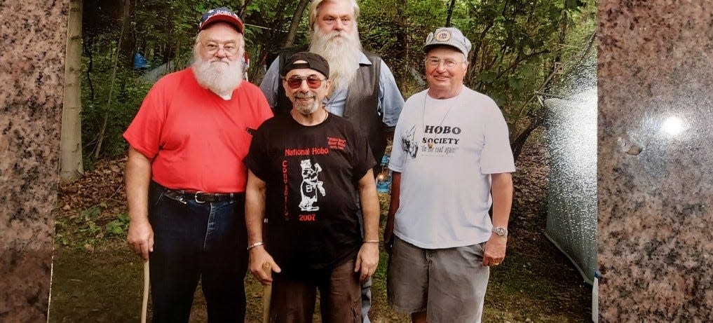 Jim Croneis, right, stands with three hobos without names who will not be at the Hobo Day on May 28 when Bucyrus Preservation Society hosts a book signing with Jim for his three-volume set "Down to Earth."