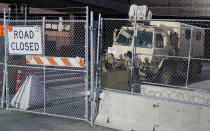National Guard troops maintain the fenced-off road leading to the Hennepin County Government Center, Monday, March 8, 2021, in Minneapolis where the trial for former Minneapolis police officer Derek Chauvin began with jury selection. Chauvin is charged with murder in the death of George Floyd during an arrest last May in Minneapolis. (AP Photo/Jim Mone)