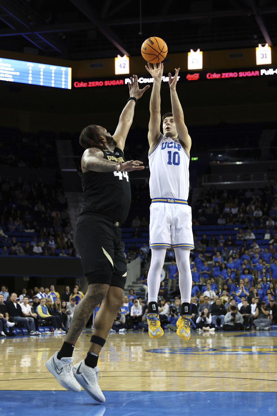 UCLA guard Lazar Stefanovic (10) shoots over Colorado center Eddie Lampkin Jr., left, during the second half of an NCAA college basketball game Thursday, Feb. 15, 2024, in Los Angeles. (AP Photo/Raul Romero Jr.)