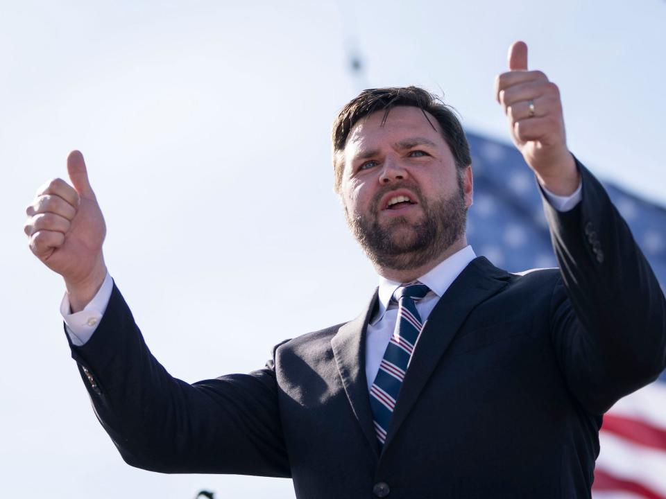 JD Vance arrives onstage during a rally