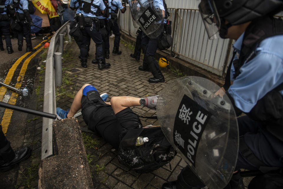 A Protester is seen lying on the ground while police surround him in Hong Kong, China. 1 July 2019. Protesters today clash with police with police using pepper spray and  batons to disperses Protesters , protesters started occupying road early morning on the 22th anniversary of the handover of Hong Kong From the United Kingdom to China. (Photo by Vernon Yuen/NurPhoto via Getty Images)