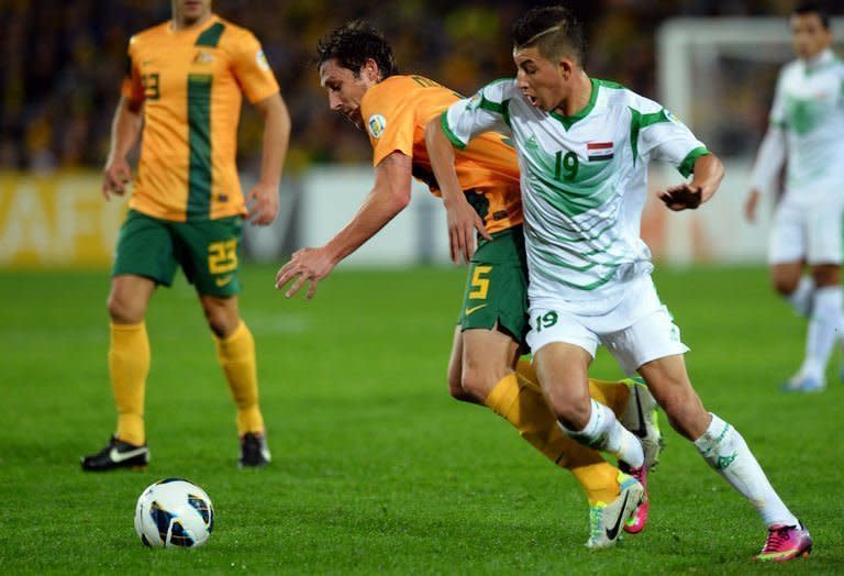 Australia's Rhys Williams (C) vies for the ball with Iraq's Dhurgham Ismael Dawoodi during their World Cup qualifier in Sydney on June 18, 2013