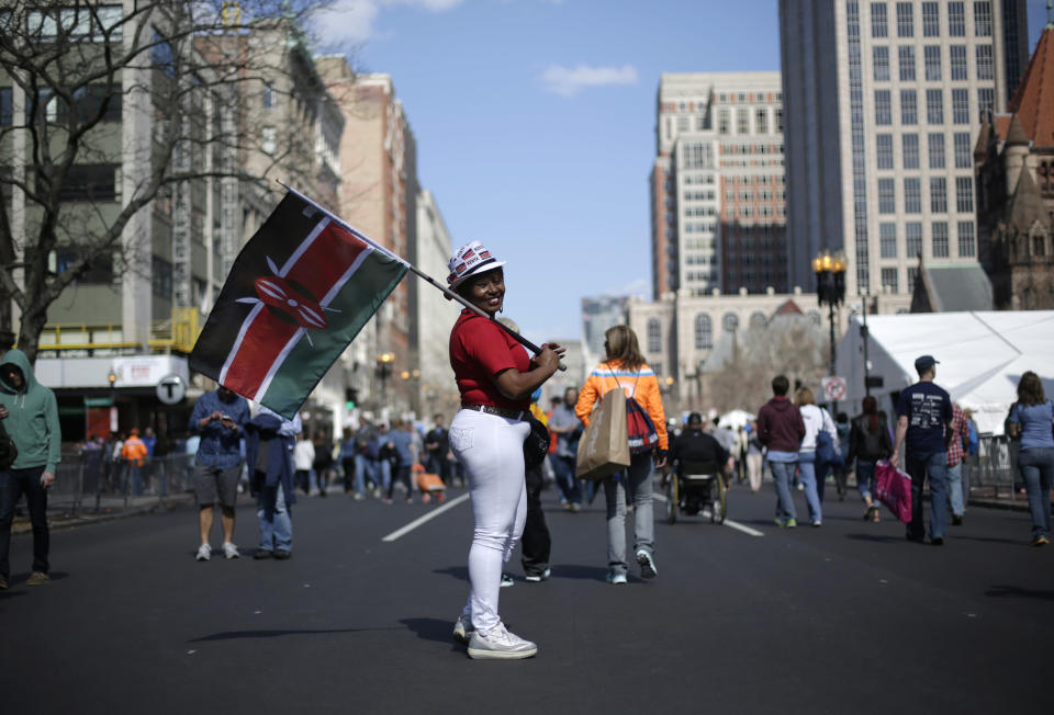 Sallie Wambui, of Kenya, displays her country's flag Saturday, April 19, 2014, along Boylston Street in Boston, in advance of Monday's 118th Boston Marathon. (AP Photo/Robert F. Bukaty)