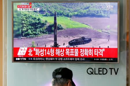 A man watches a TV broadcasting still photographs released by North Korea's state-run television KRT of North Korea's Hwasong-14 missile, at a railway station in Seoul, South Korea. REUTERS/Kim Hong-Ji