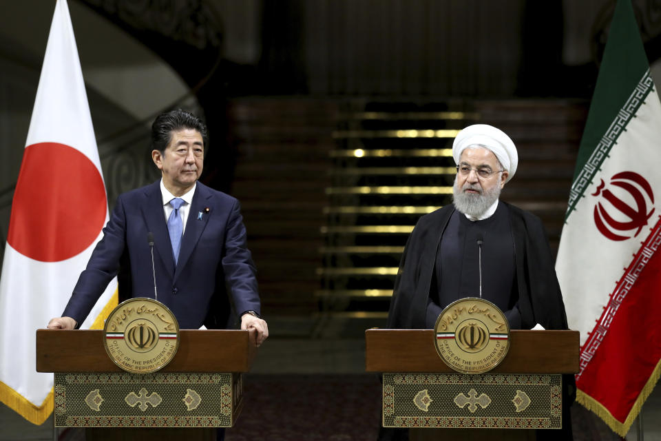 Iranian President Hassan Rouhani, right, speaks with media during a joint press conference with Japanese Prime Minister Shinzo Abe, after their meeting at the Saadabad Palace in Tehran, Iran, Wednesday, June 12, 2019. The Japanese leader is in Tehran on an mission to calm tensions between the U.S. and Iran. (AP Photo/Ebrahim Noroozi)