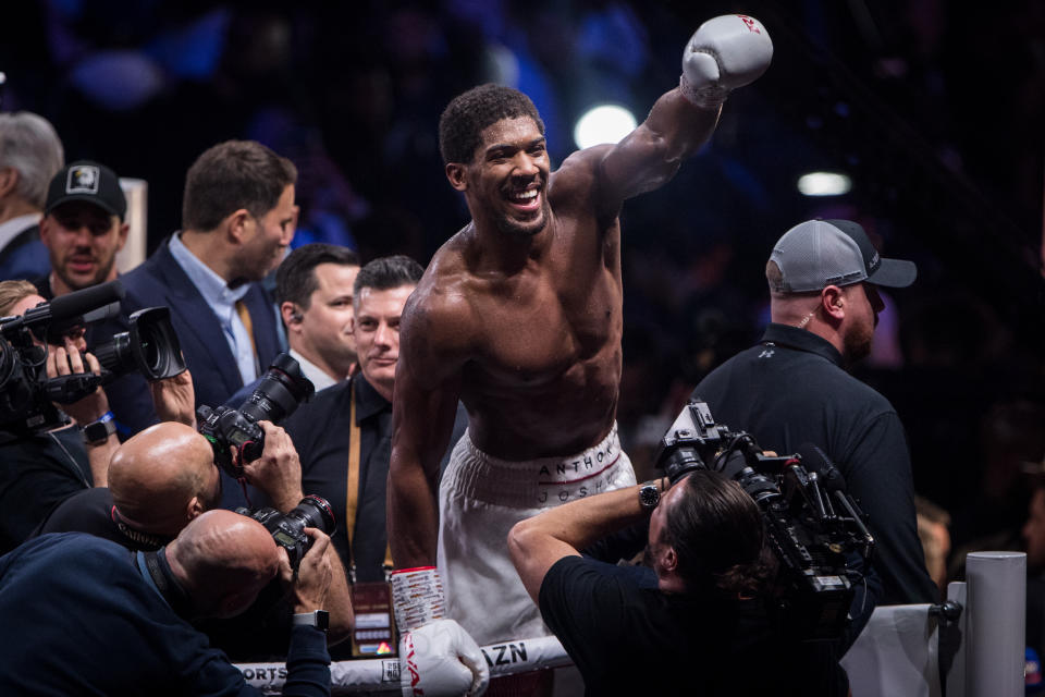 dpatop - 08 December 2019, Saudi Arabia, Diriyah: Britain's professional boxer Anthony Joshua (C) celebrates defeating US-Mexican Andy Ruiz Jr (Not Pictured) in their World Heavyweight Championship contest at the Diriyah Arena. Photo: Oliver Weiken/dpa (Photo by Oliver Weiken/picture alliance via Getty Images)