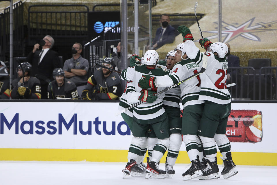 Minnesota Wild players celebrate a goal against the Vegas Golden Knights during the first period of Game 7 of an NHL hockey Stanley Cup first-round playoff series Friday, May 28, 2021, in Las Vegas. (AP Photo/Joe Buglewicz)