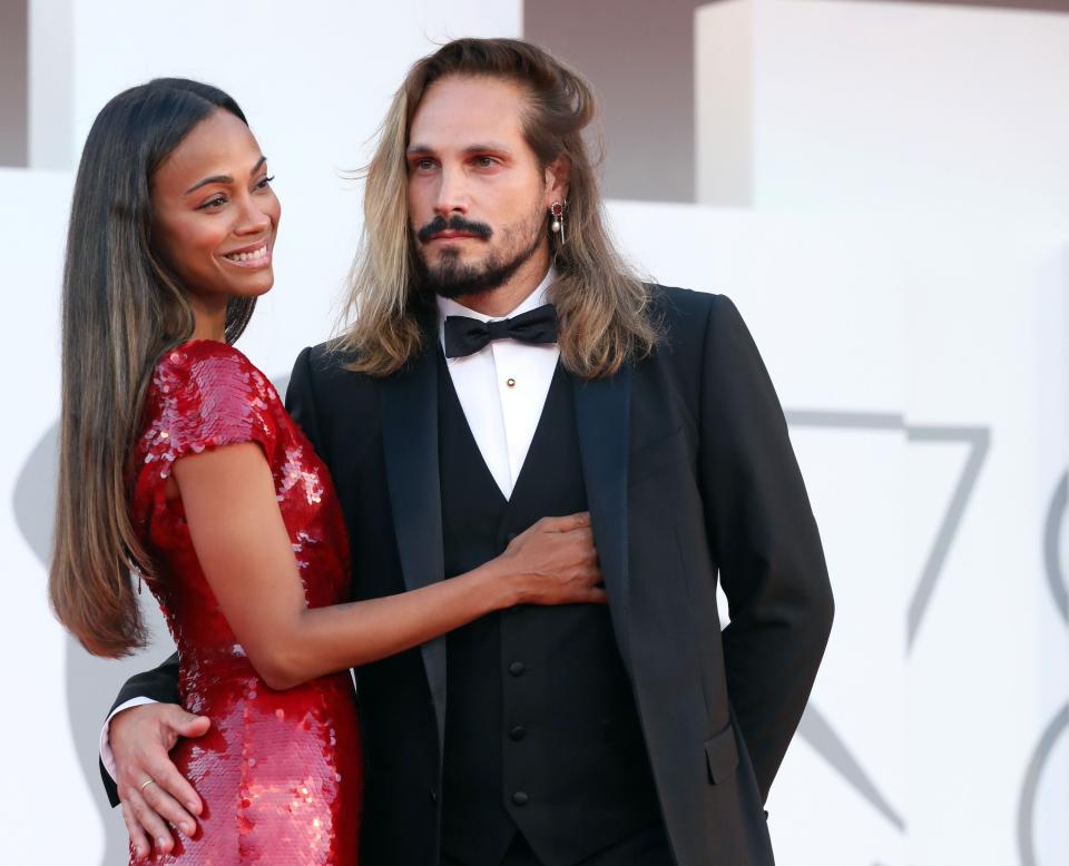 Zoe Saldana and Marco Perego posing at an event