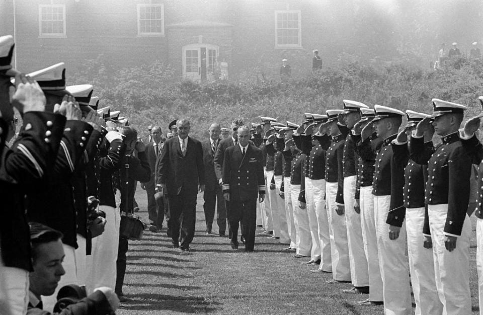 President Lyndon Johnson Reviews honor guard during commencement visit to Coast guard Academy in New London, Conn., June 3, 1964. He is accompanied by Rear Admiral Willard J. Smith, Academy superintendent.