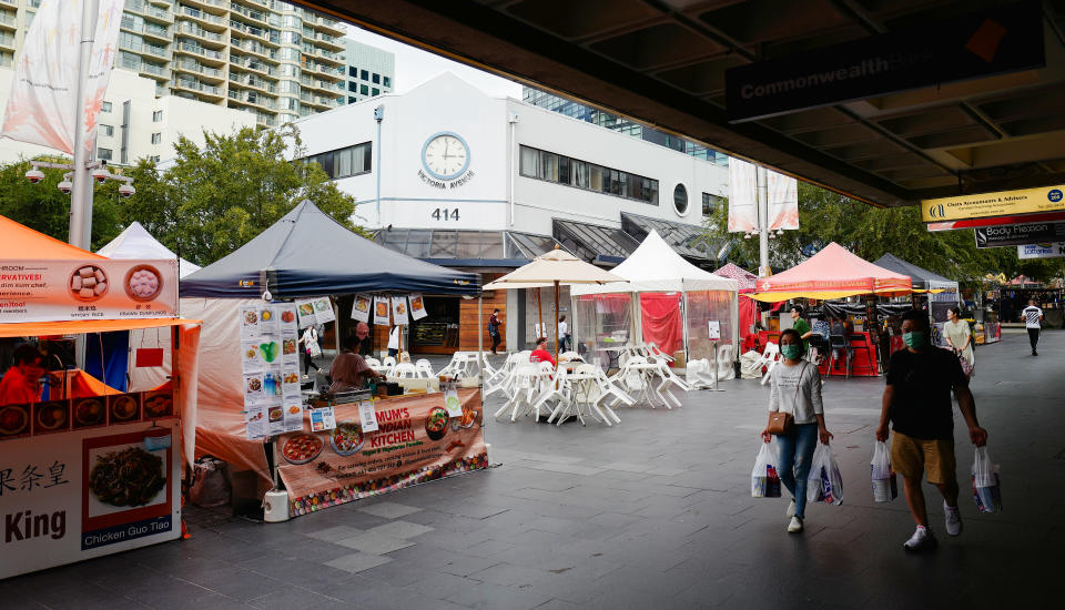 People out in the suburb of Chatswood wear face masks.