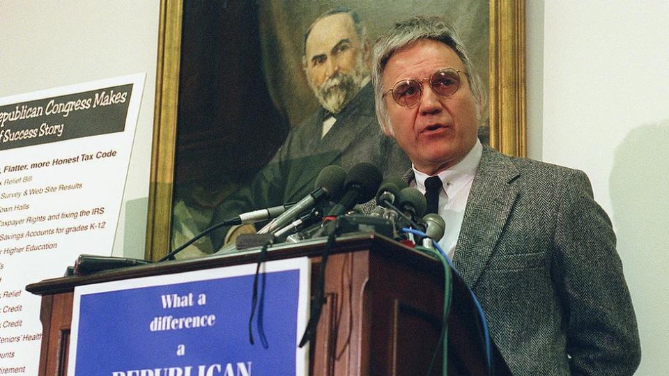 Jim Traficant at a podium in front of a painting