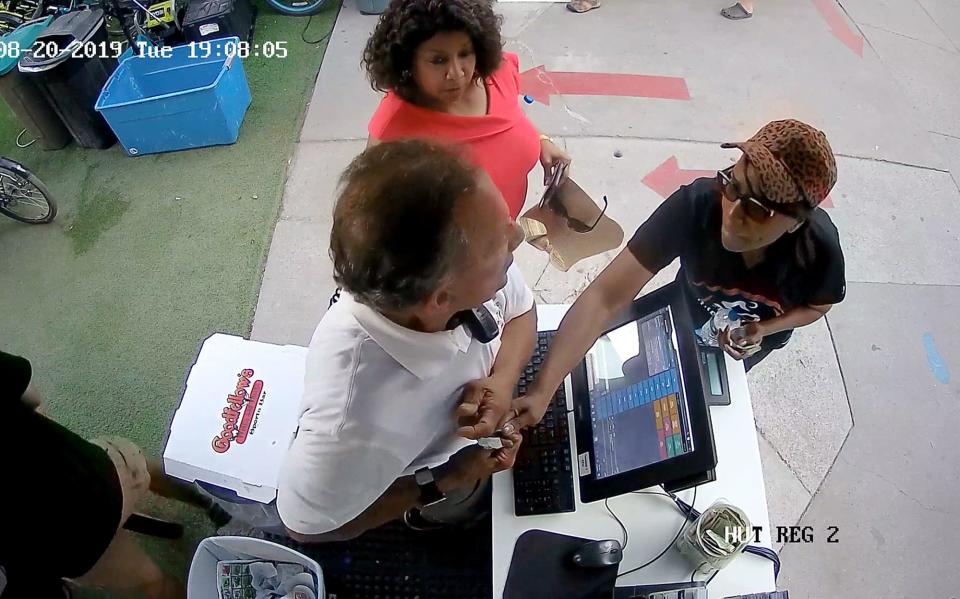 A frame capture from a video shows two women who are metro-Detroit judges standing inside the Mackinac Island Bike Shop during their dispute with the owner, Ira Green, who is at the cash register holding a receipt. As he refuses their demand for a discount on a $23 charge for renting bikes, Detroit 36th District Judge Demetria Brue reaches out and tries to grab the receipt, to which Green clings, causing it to rip. The dispute triggered a state investigation. According to investigators, Brue initially accused Green of assault, then dropped the accusation, then told investigators she’d never said it. Brue denies that she lied. The other judge, Southfield 46th District Judge Debra Nance, is accused by state investigators of lying about the incident, a charge she also denies.