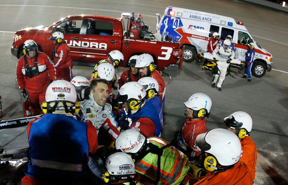 KANSAS CITY, KS – MAY 13: Safety crew workers place Aric Almirola, driver of the #43 Smithfield Ford, on a stretcher after cutting off the roof of his car after a crash during the Monster Energy NASCAR Cup Series Go Bowling 400 at Kansas Speedway on May 13, 2017 in Kansas City, Kansas. (Photo by Sean Gardner/Getty Images)