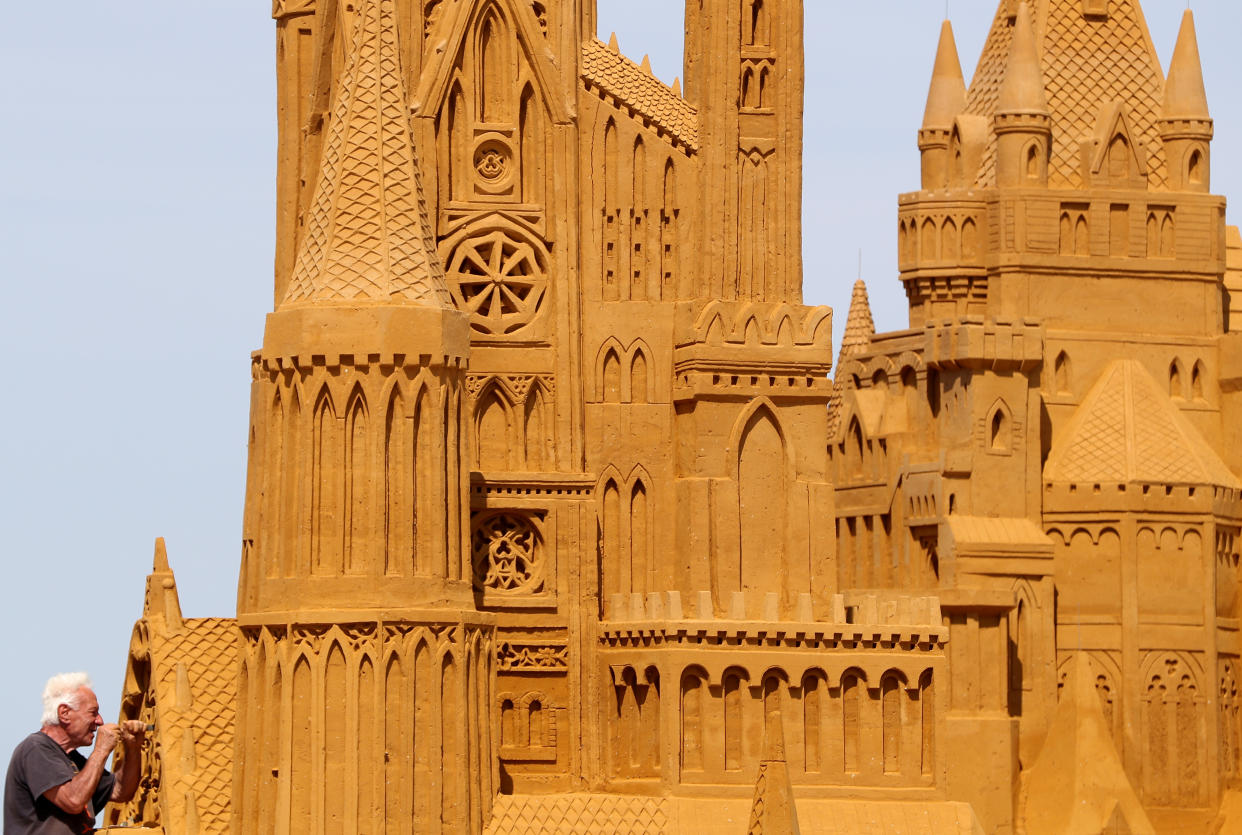 A sand carver works on a sculpture during the Sand Sculpture Festival "Dreams" in Ostend, Belgium June 18, 2019. (Photo: Yves Herman/Reuters)