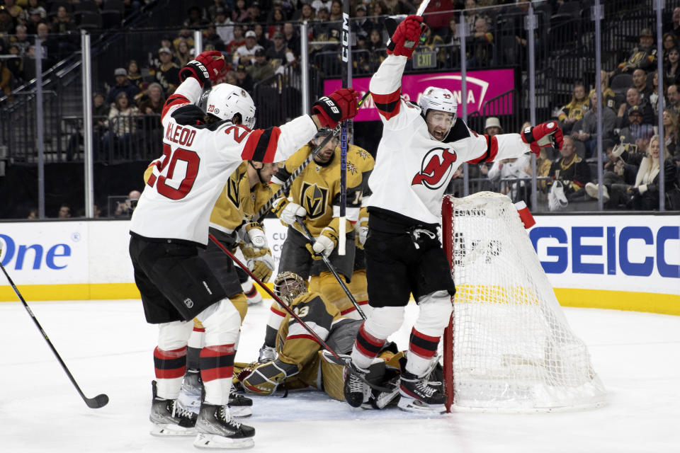 New Jersey Devils center Michael McLeod (20) and left wing Miles Wood, right, celebrate after Wood scored a goal against the Vegas Golden Knights during the third period of an NHL hockey game Friday, March 3, 2023, in Las Vegas. (AP Photo/Ellen Schmidt)