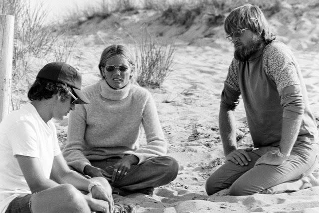 <p>Pamela Schall/WWD/Penske Media via Getty </p> Steven Spielberg (L) and Susan Backlinie (C) prepare for filming during production of 'Jaws' on the island of Martha's Vineyard, Massachusetts, on July 15, 1974