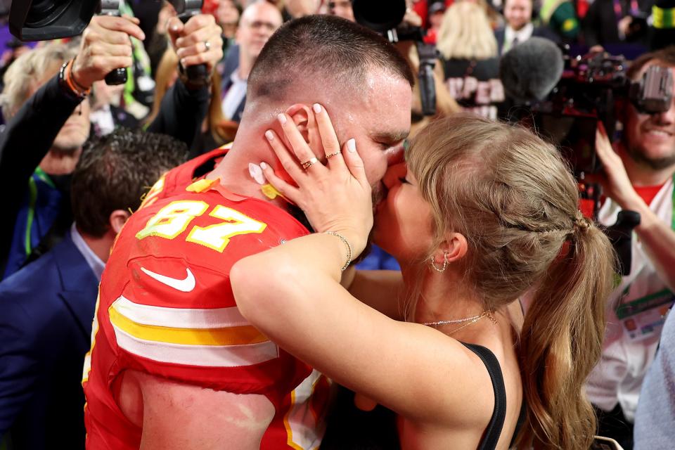 Travis Kelce of the Kansas City Chiefs kisses Taylor Swift after winning the Super Bowl.