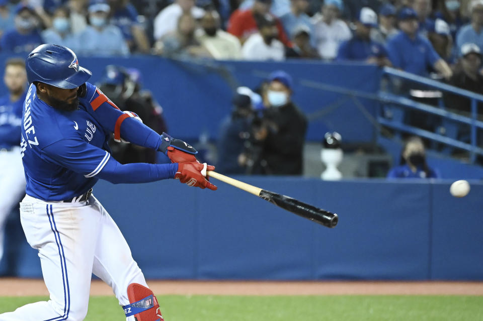 Toronto Blue Jays' Teoscar Hernandez hits a double in the fifth inning of a baseball game against the Tampa Bay Rays in Toronto on Monday, Sept. 13, 2021. (Jon Blacker/The Canadian Press via AP)