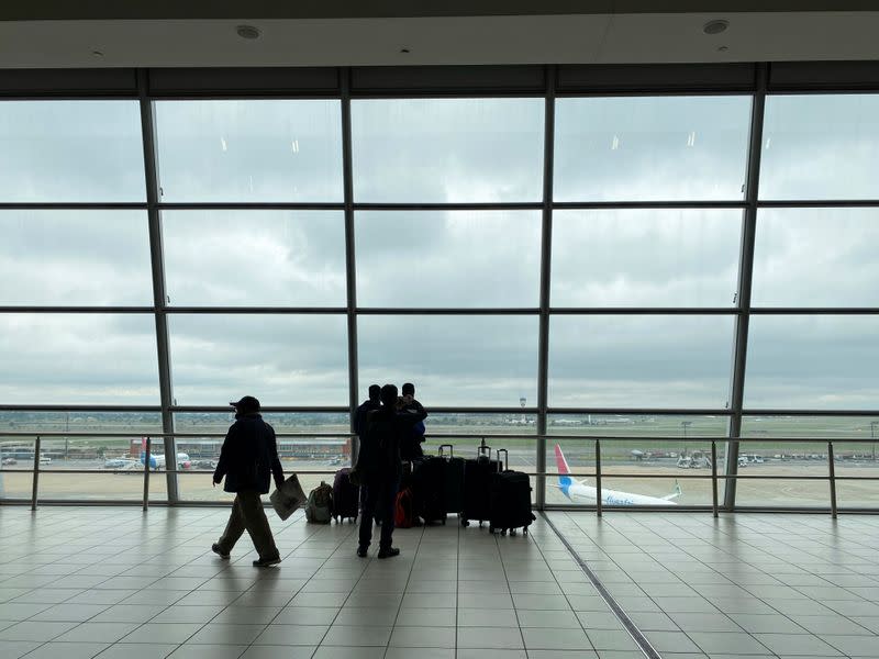 Passengers wait to board flights at O.R. Tambo International Airport in Johannesburg