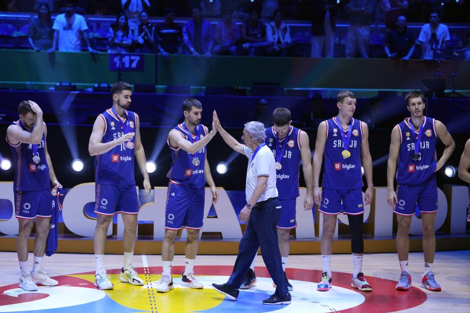 Serbia celebrates with their silver medals after losing to Germany in the championship game of the Basketball World Cup in Manila, Philippines, Sunday, Sept. 10, 2023. (AP Photo/Michael Conroy)