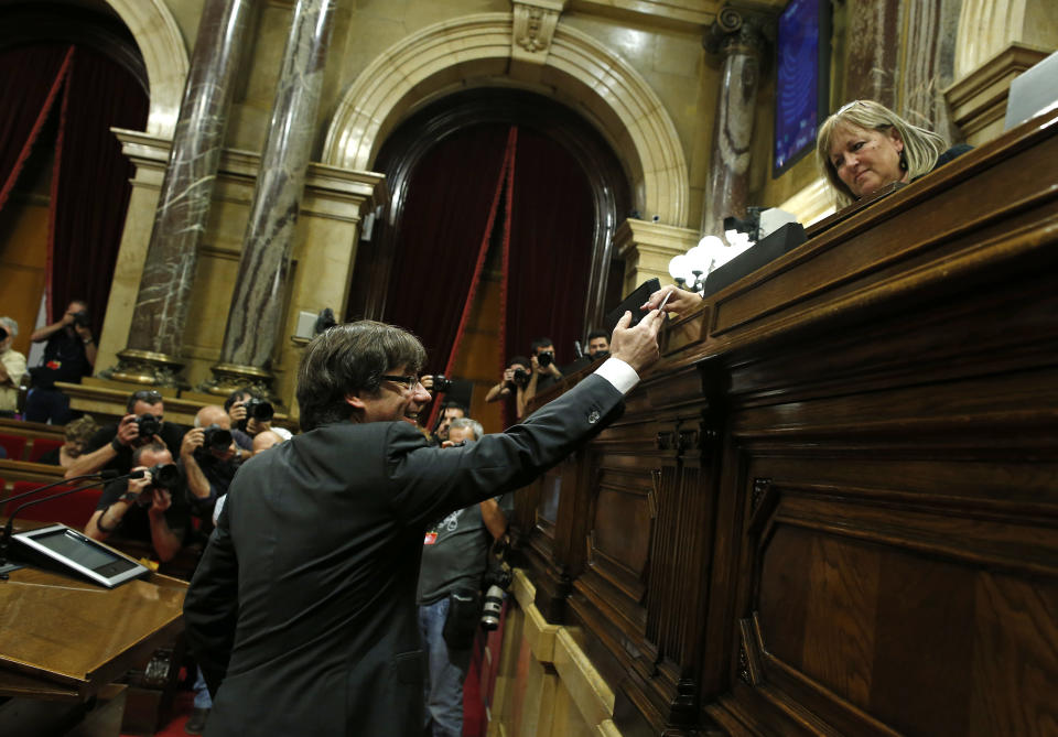 <p>Catalan President Carles Puigdemont casts his ballot in a vote on independence in the Catalan parliament in Barcelona, Spain, Friday, Oct. 27, 2017. (Photo: Manu Fernandez/AP) </p>