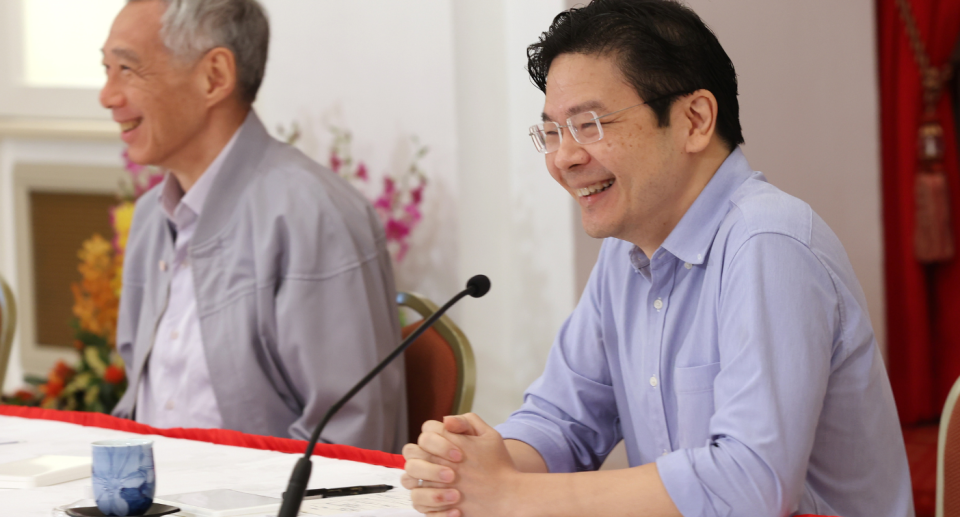 Finance Minister Lawrence Wong (right), who was announced as heir apparent to Prime Minister Lee Hsien Loong, addresses reporters alongside Lee at a press conference on Saturday, 16 April 2022. 