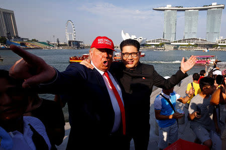 Howard, an Australian-Chinese impersonating North Korean leader Kim Jong-un, and Dennis Alan, impersonating U.S. President Donald Trump, meet at Merlion Park in Singapore June 8, 2018. REUTERS/Edgar Su