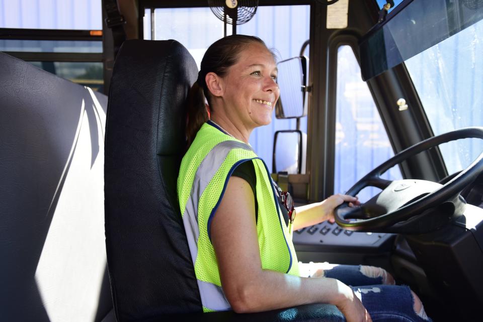 Nancy Whitmore, a school bus driver and trainer for the Port Huron School District, checks her side mirrors before driving during a training exercise at the Port Huron Area School District Bus Depot on Thursday, August 11, 2022.