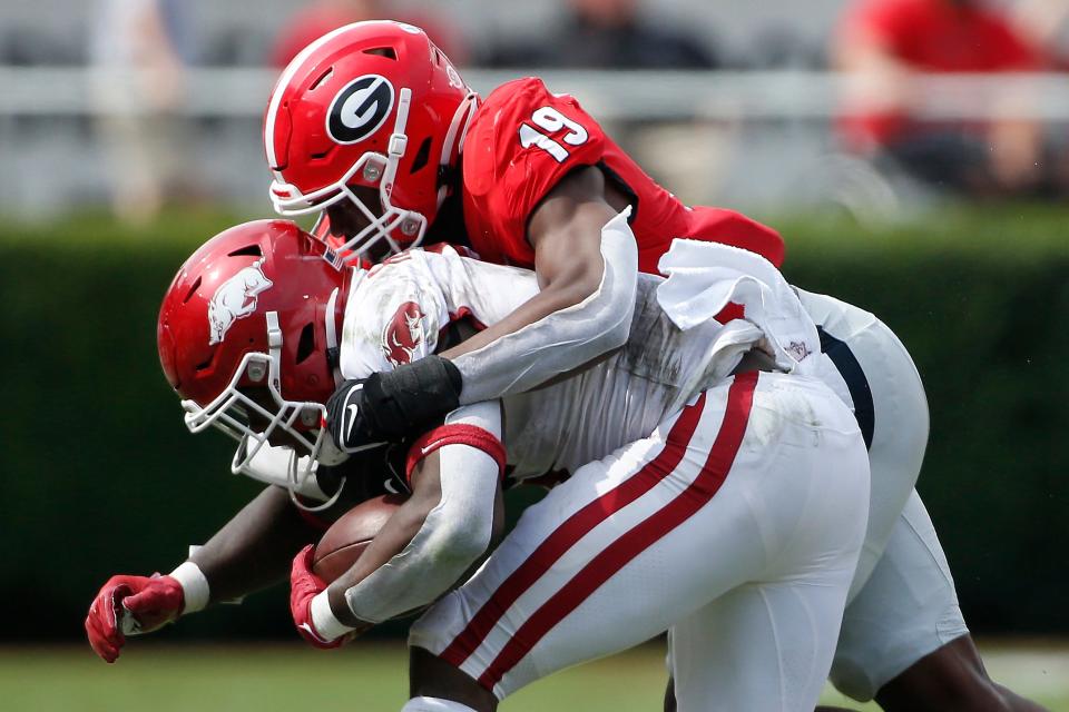 Georgia outside linebacker Adam Anderson (19) takes down Arkansas running back Raheim Sanders (5) during an NCAA college football game between Arkansas and Georgia in Athens, Ga., on Saturday, Oct. 2, 2021. Georgia won 37-0.