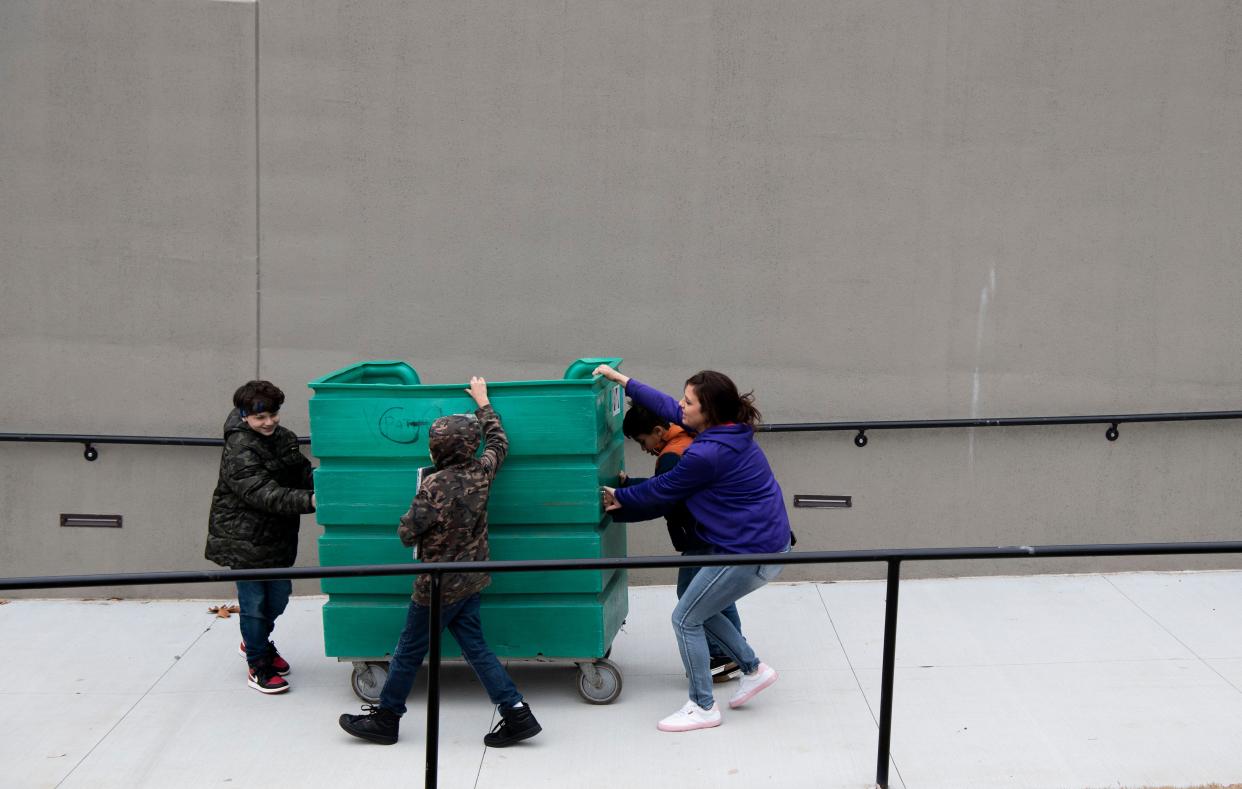 Aiden Byrd, 10, Kayleb Byrd, 9, Cash Johnson, 8, help their mother, Paige Maymi direct a bin full of their belongings as the family moves in to the brand new campus for women and children at The Nashville Rescue Mission in Nashville, Tenn., Thursday, Jan. 4, 2024.