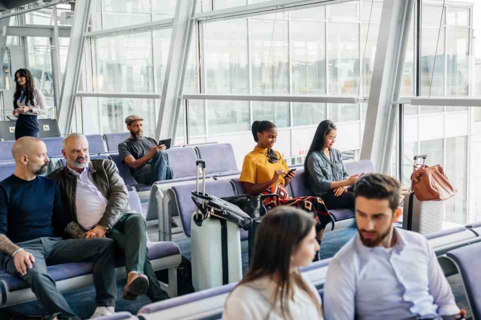 <p>Hinterhaus Productions/Getty Images</p> Passengers waiting in an airport terminal.