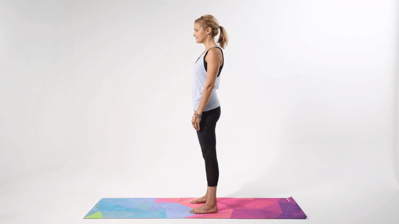 instructor demonstrating how to do a forward fold with clasp yoga shoulder opener pose