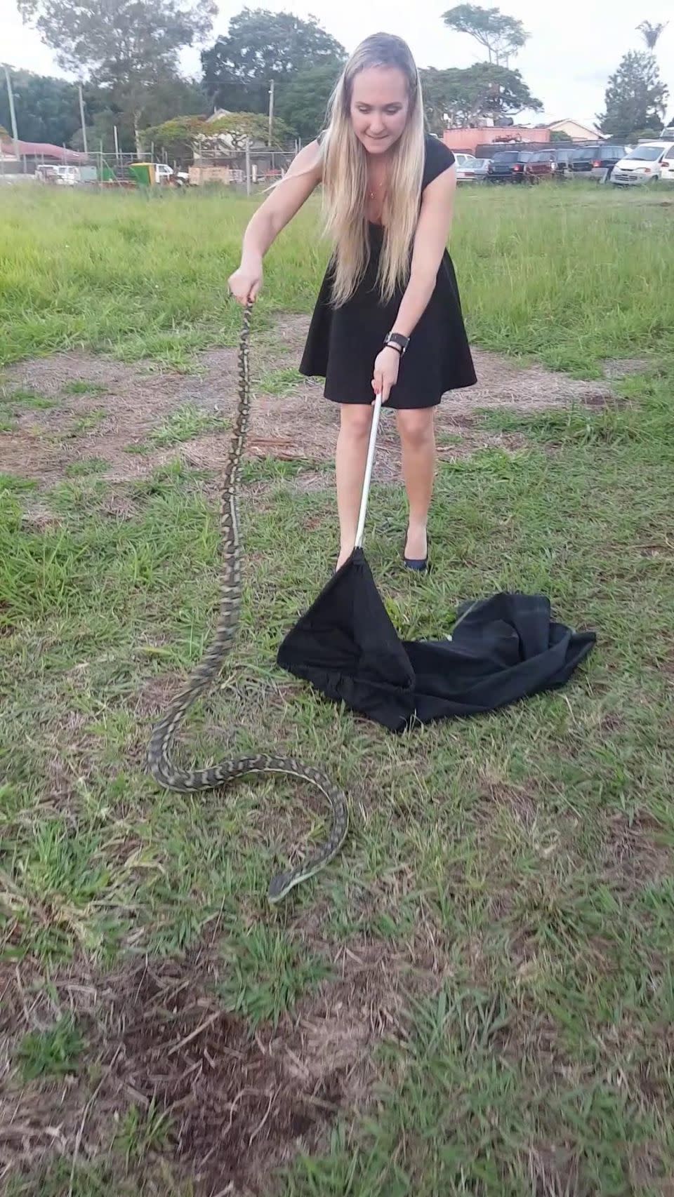 Tetiana Nazarova conquered her lifetime fear of snakes by successfully capturing a massive 2.5 metre carpet snake in a backyard. Photo: Caters News